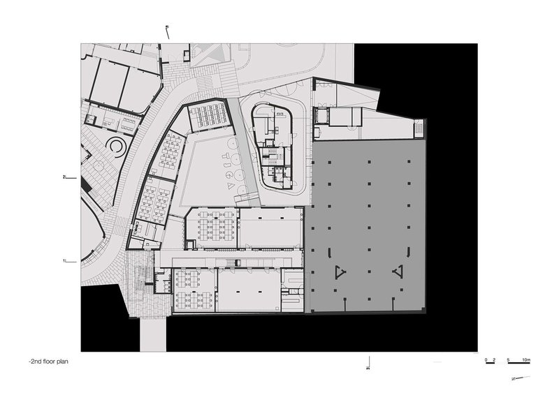 Second floor plan drawing showing auditorium, corridors, parking area, and adjacent volumes