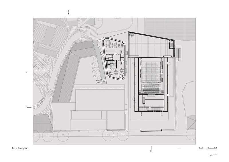 First subterranean floor plan showing reduced building footprint with performance hall and curved courtyard structure