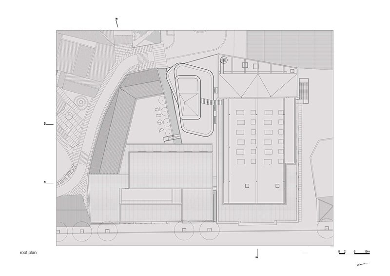 Roof plan drawing showing triangular skylight structure above main hall and organic-shaped courtyard pavilion roof