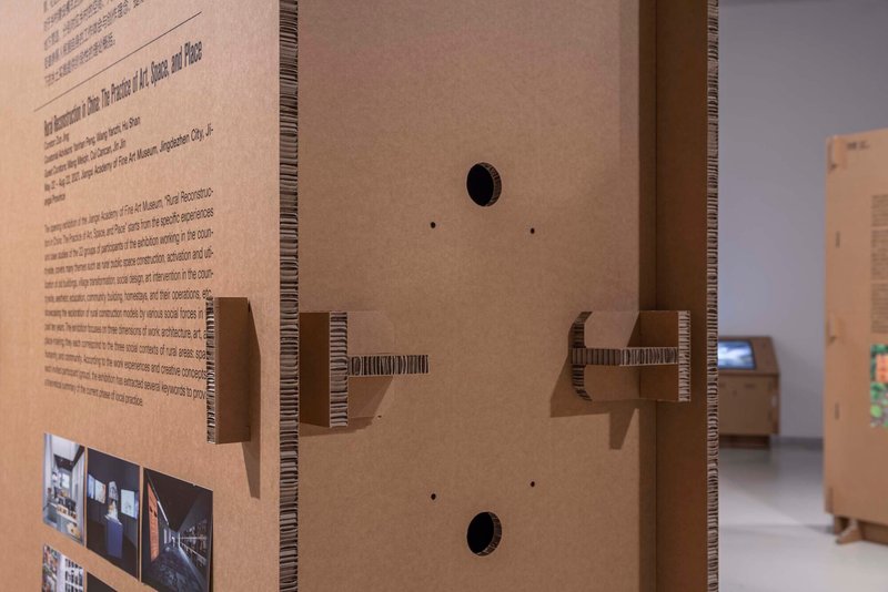 Detail of corrugated cardboard edge with cantilevered shelf brackets and circular cable ports