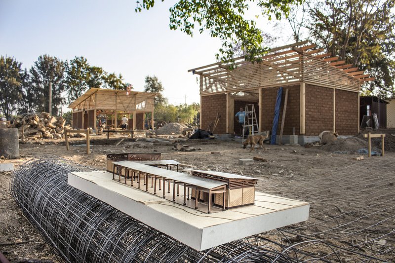 Physical model on the construction site showing timber frame structure and interior layout