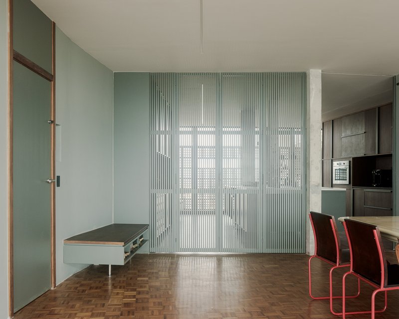 Translucent fluted glass wall system with integrated doorway and fold-down bench seat