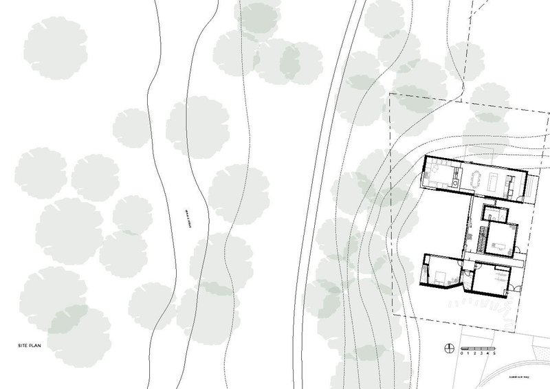 Site plan drawing showing building footprint among existing trees and contour lines