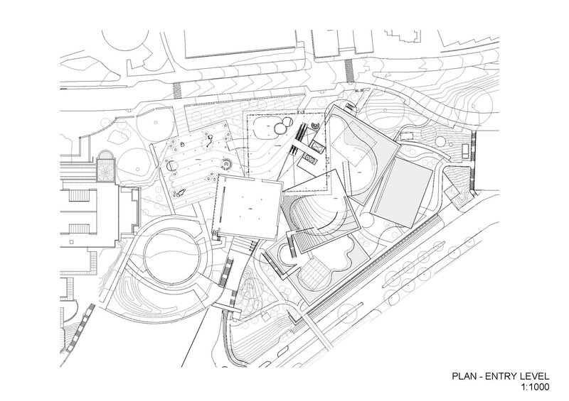Entry level floor plan drawing showing irregular building volumes around landscaped terraces and circulation paths