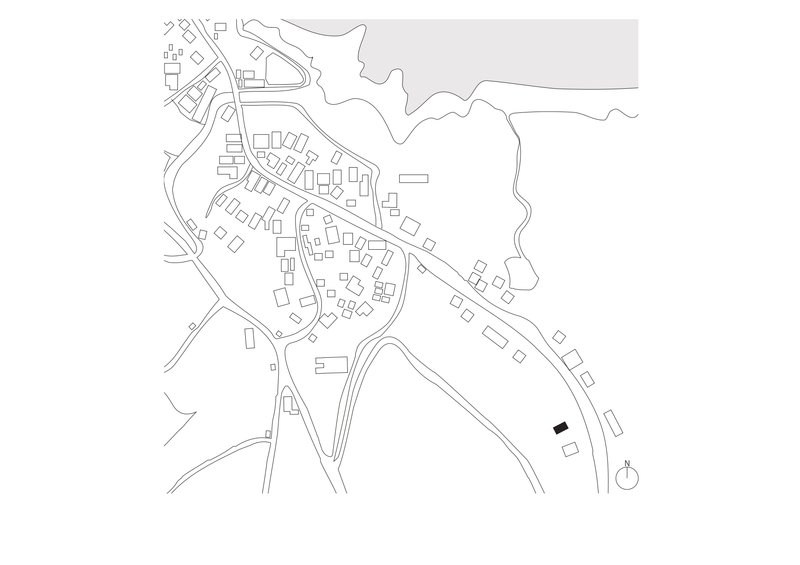 Site plan drawing showing a residential cluster along a waterfront with roads and building footprints