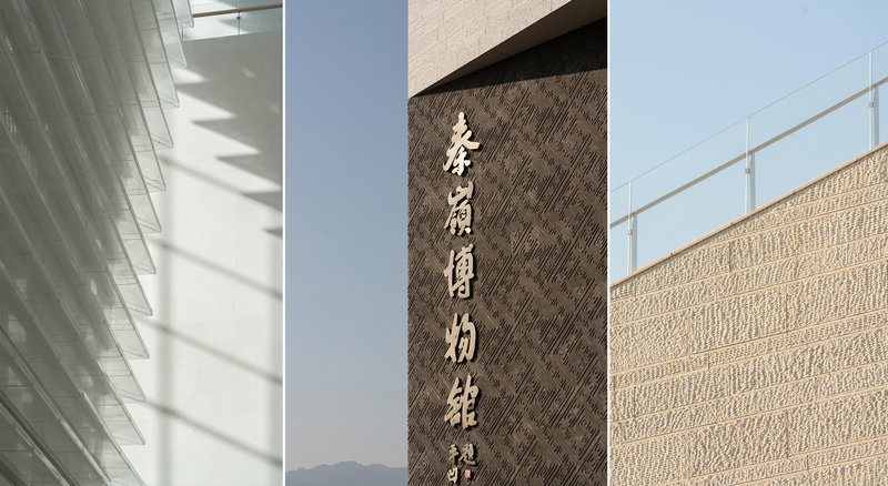 Vertical stone signage panel with carved characters between textured stone wall surfaces in daylight