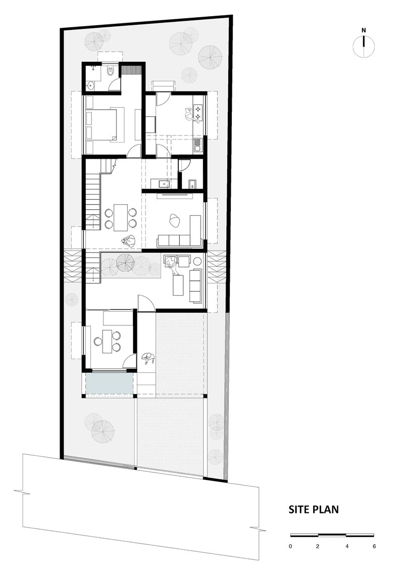 Site plan drawing showing a narrow dwelling with internal courtyard and two staircases