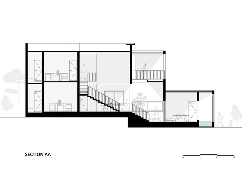 Section drawing showing split-level interior spaces connected by two staircases with human figures