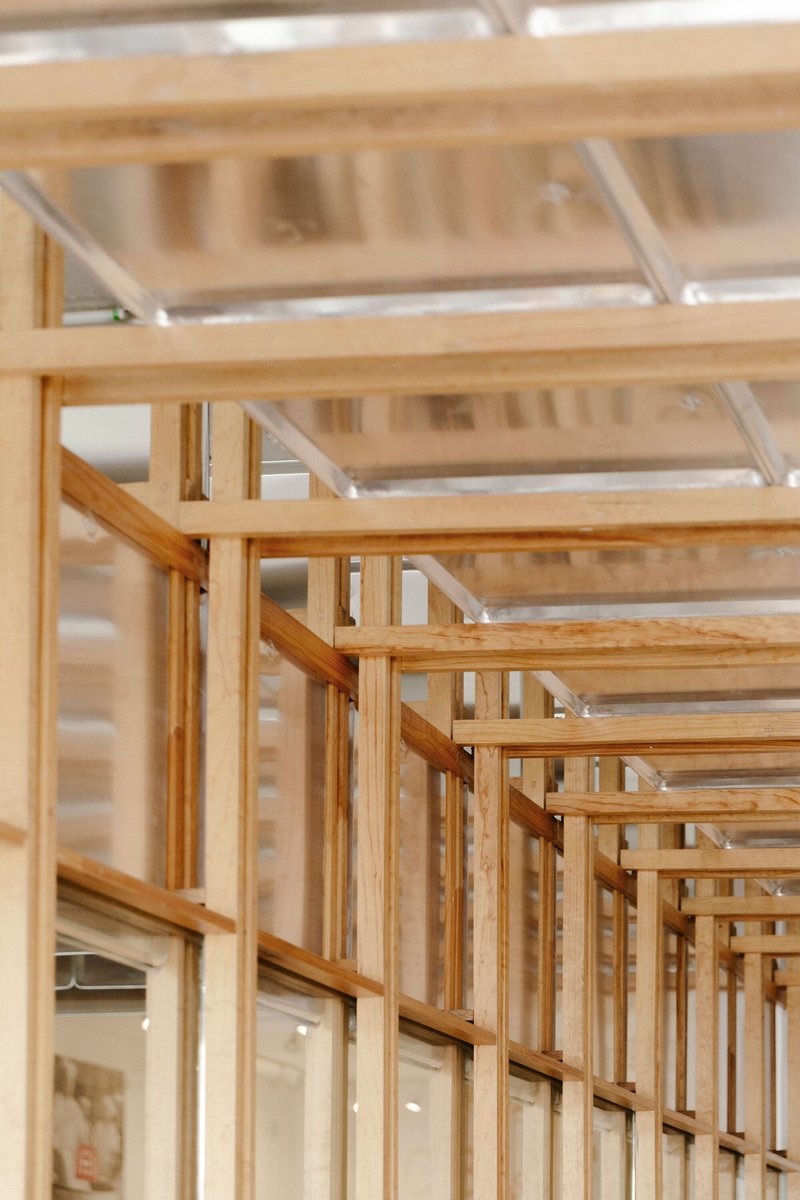 Close-up of layered timber joinery forming the structural grid and display framework