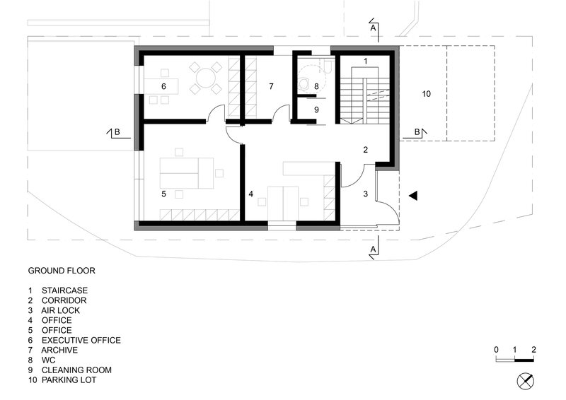 Ground floor plan showing offices arranged around a central staircase with adjacent parking lot