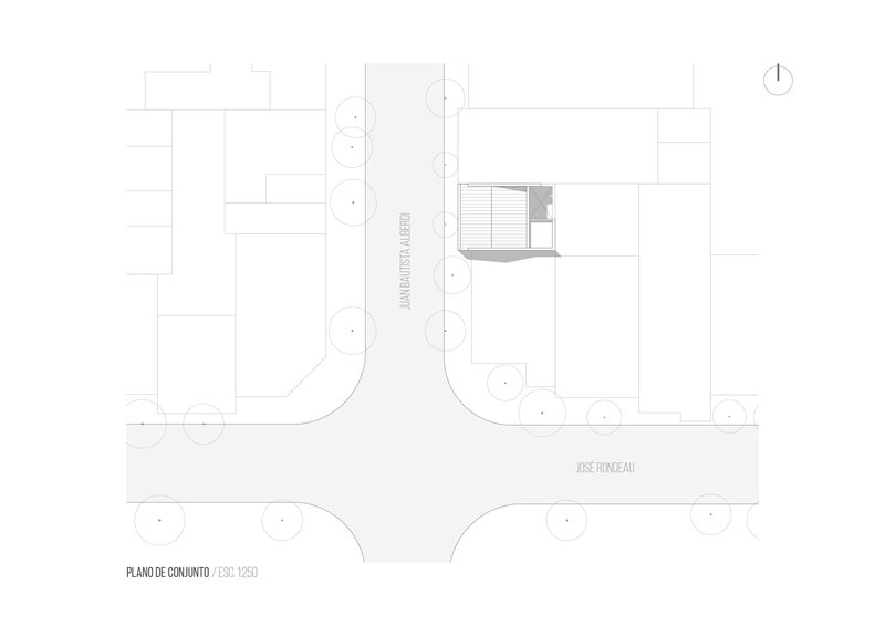 Site plan drawing showing a small structure positioned on a corner lot with street trees