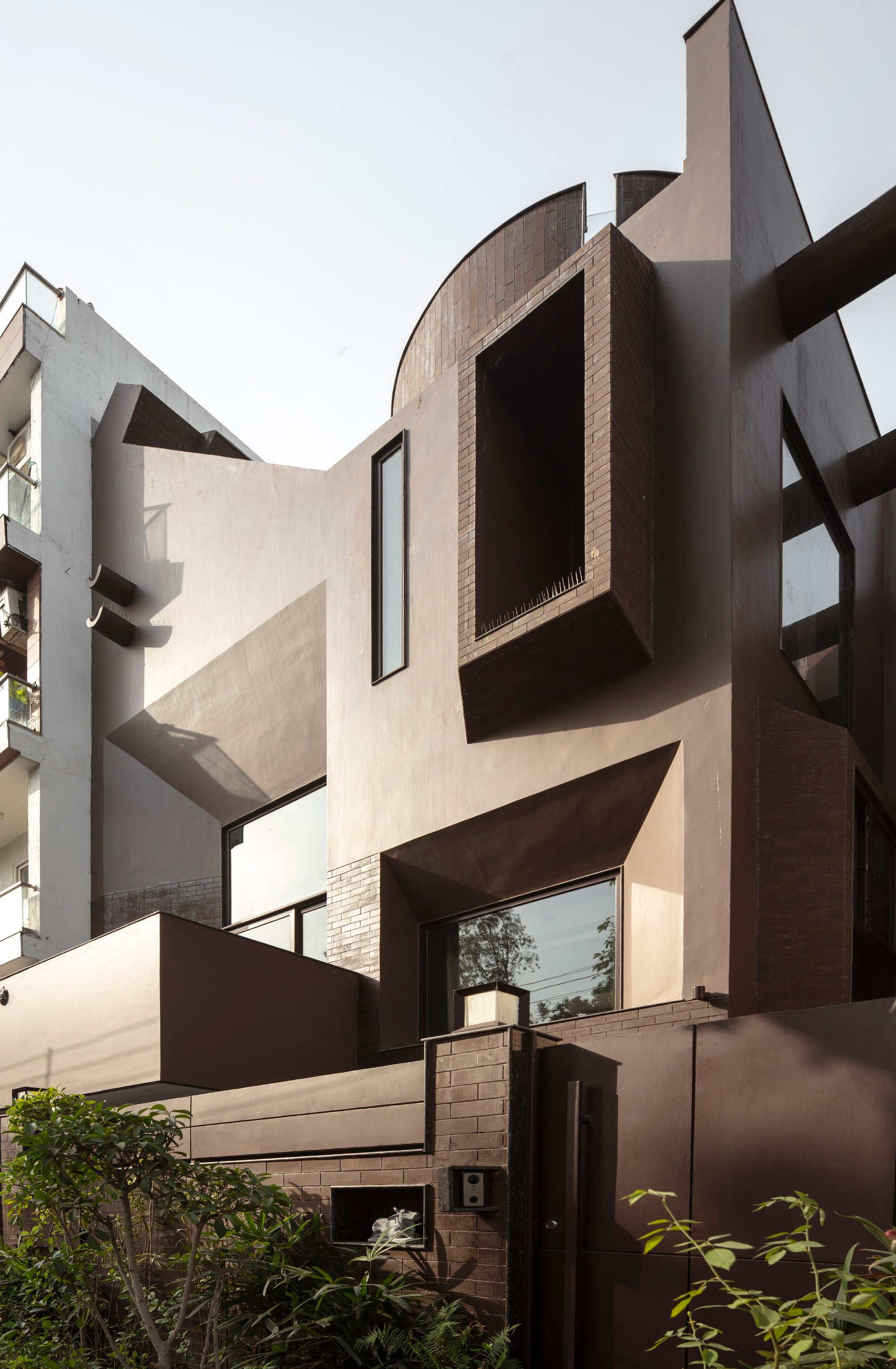 RENESA Channels Corbusian Brutalism into a Four-Story New Delhi Home Clad in Burnt Sienna Brick