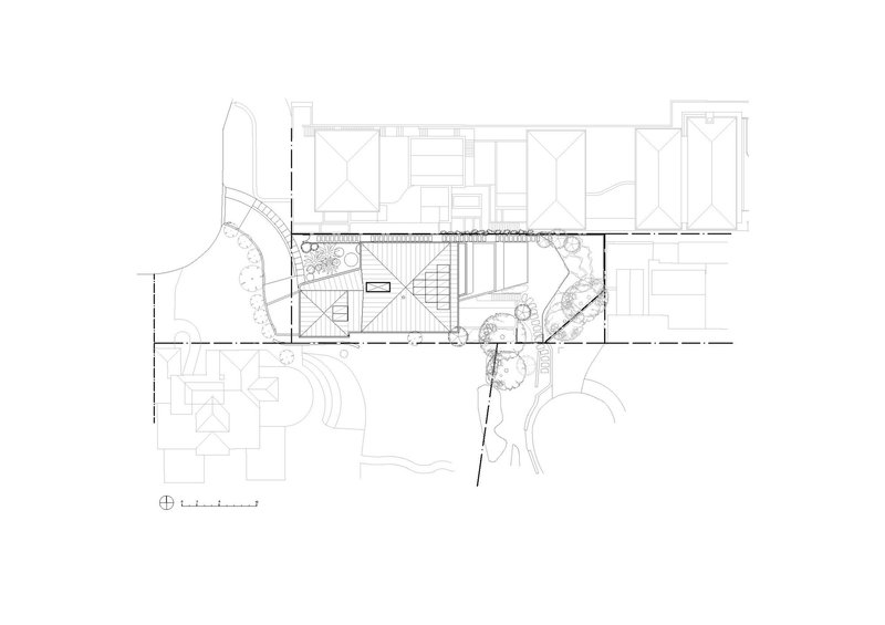Floor plan showing central staircase with flanking planted courtyards and adjacent rooms