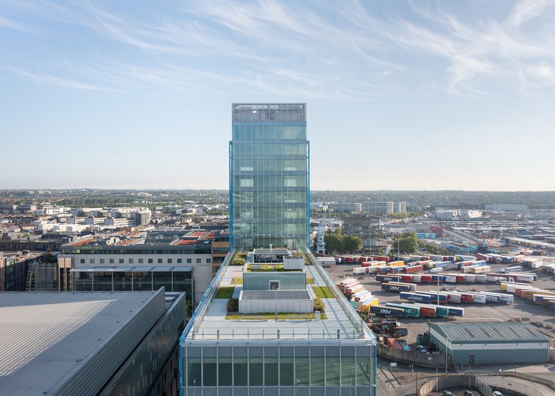 Elevated view of the tower above rooftop terraces and surrounding industrial landscape