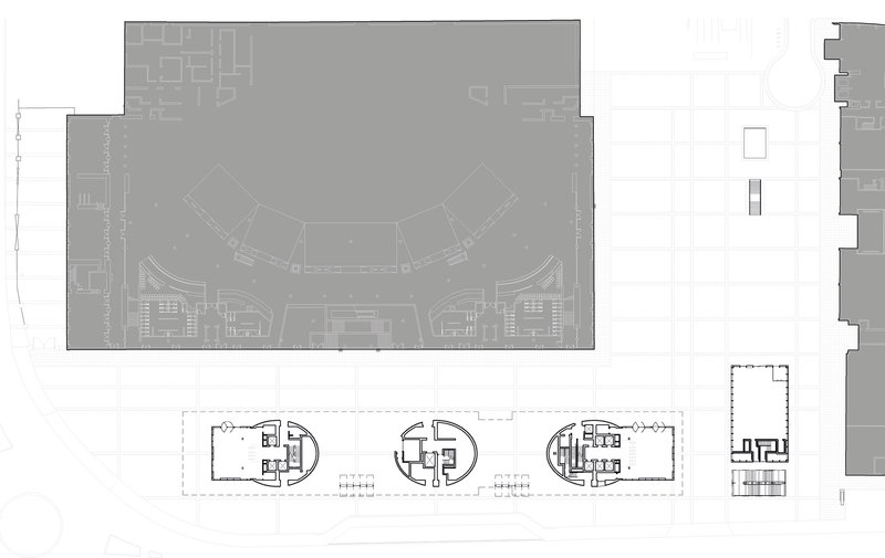 Floor plan drawing showing a curved atrium space above a ground floor with service cores