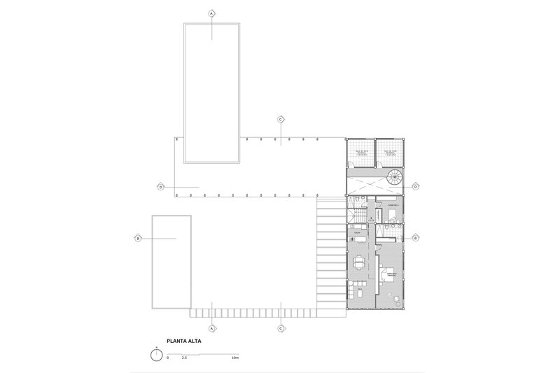Upper floor plan drawing showing residential spaces and terraces along one wing
