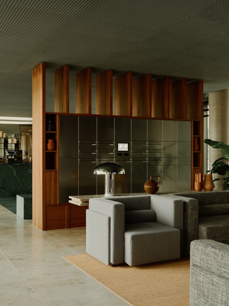 Lounge seating cluster beside a timber and olive panel storage wall under a slatted ceiling