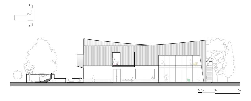 Section drawing showing two-story building with curved roof and adjacent trees
