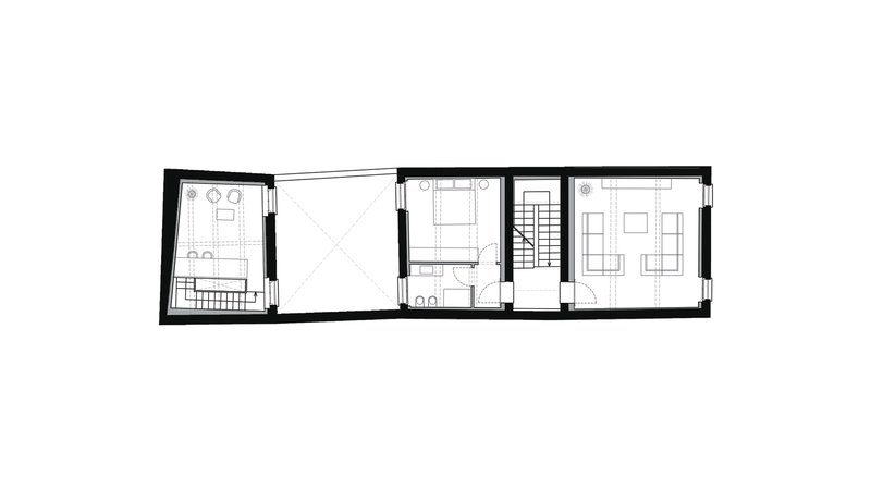 Floor plan drawing showing a narrow multi-room layout with staircase and angled wall at left