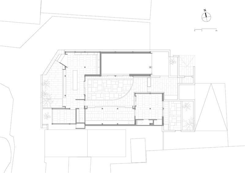 Floor plan drawing showing a different level with curved walls and exterior planted areas