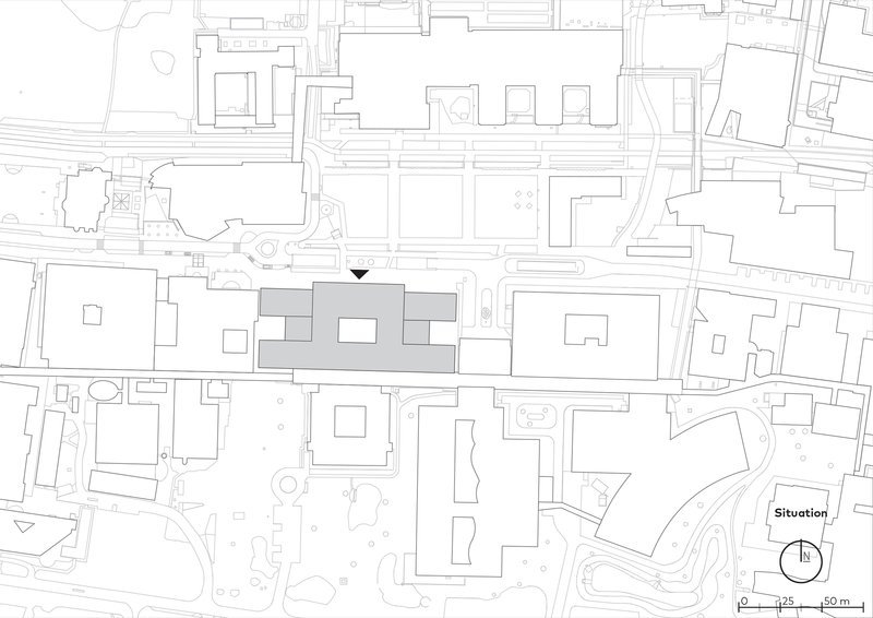 Site plan drawing situating three linked volumes within the surrounding urban fabric