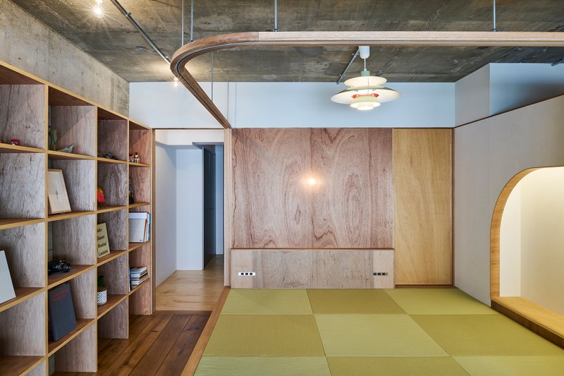 Raised tatami mat platform with curved timber curtain rail and pendant light overhead