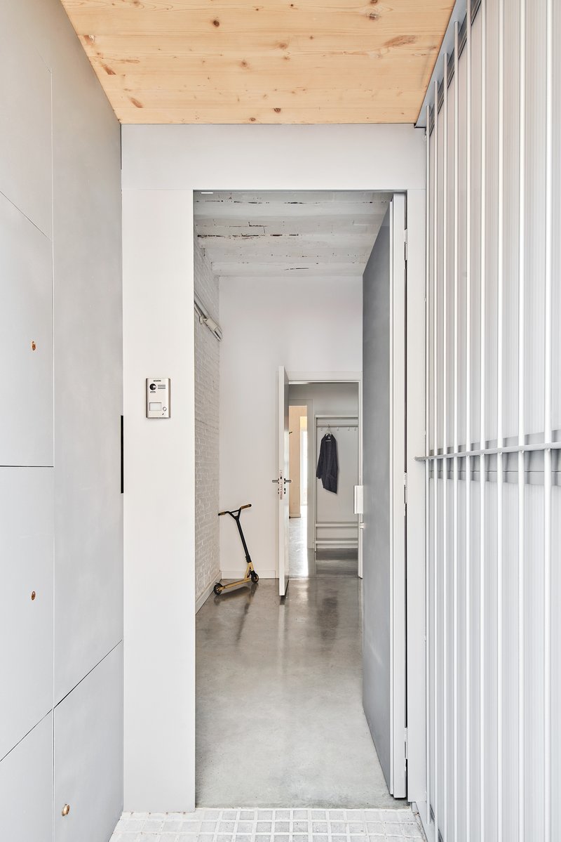 Corridor view through aligned doorways with scooter parked midway along polished concrete floor