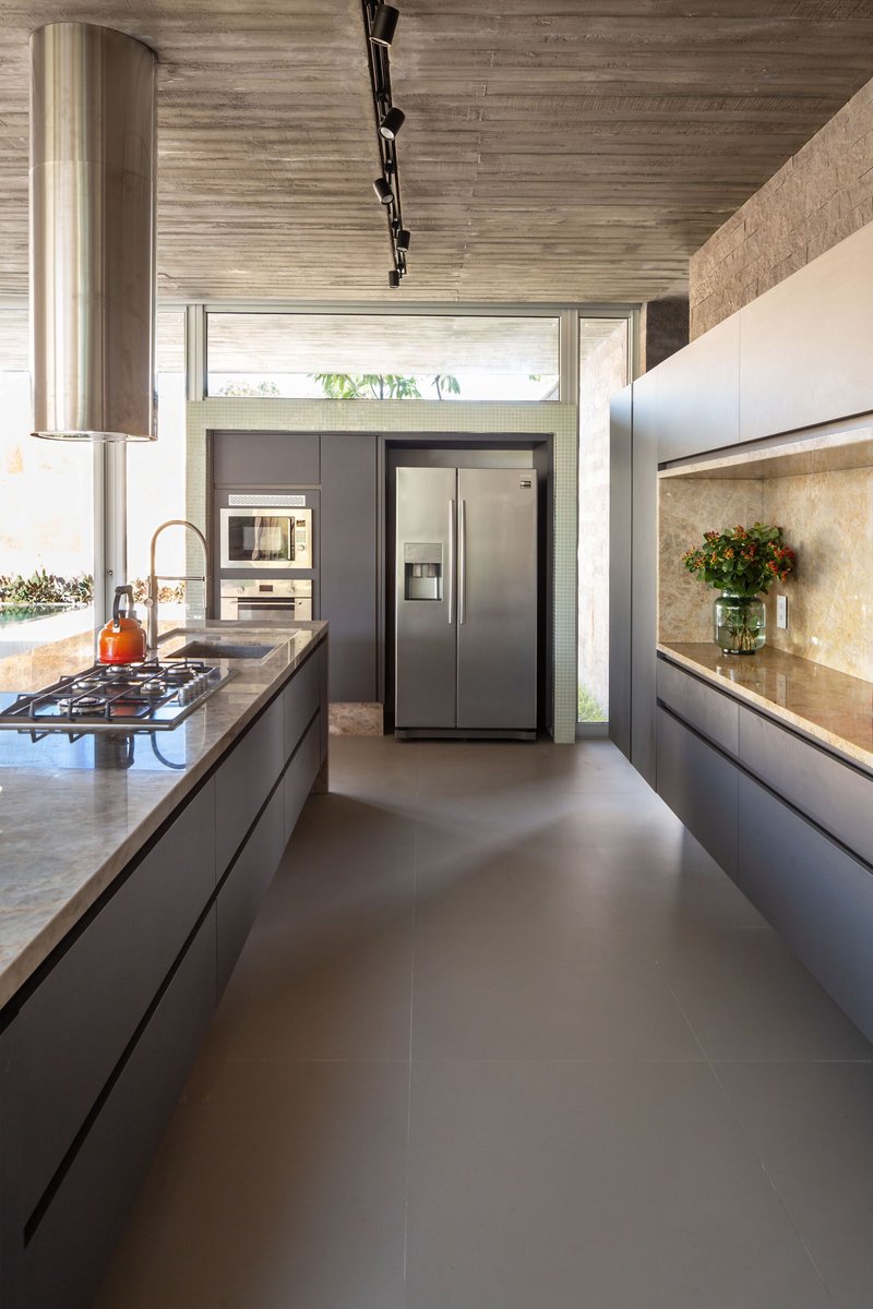 Kitchen with striped timber ceiling, dark cabinetry, and clerestory windows bringing in natural light