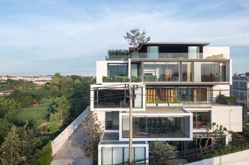 Stacked terraces with glass balustrades and planted beds overlooking distant landscape
