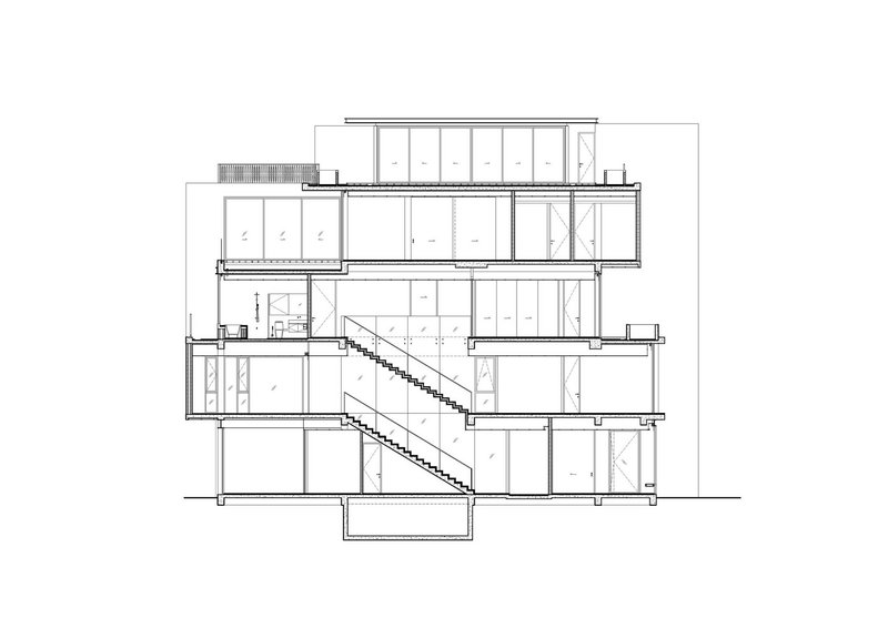 Section drawing displaying a long diagonal staircase traversing multiple split levels within the structure