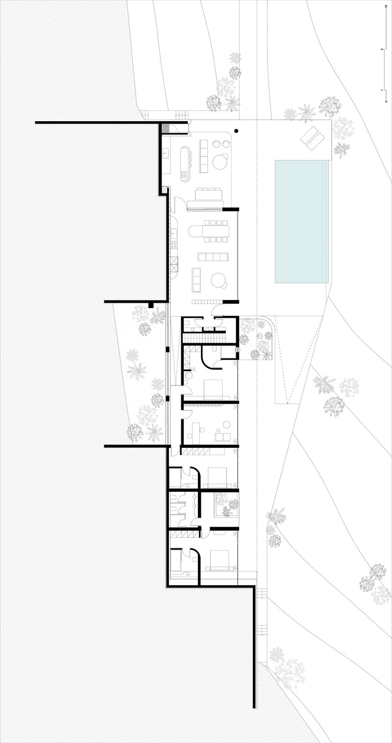 Floor plan drawing showing rooms arranged around a swimming pool with adjacent trees and landscaping