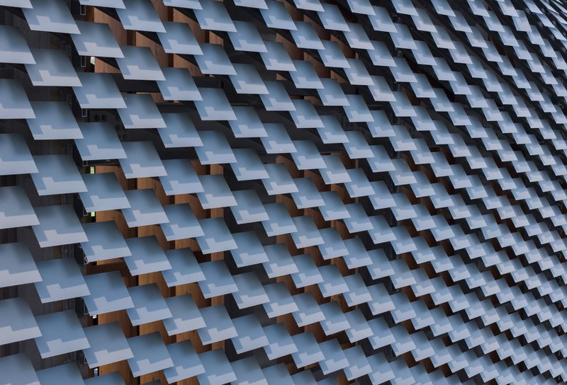 Close-up of interlocking ceramic tile roof cladding creating a repetitive diagonal pattern