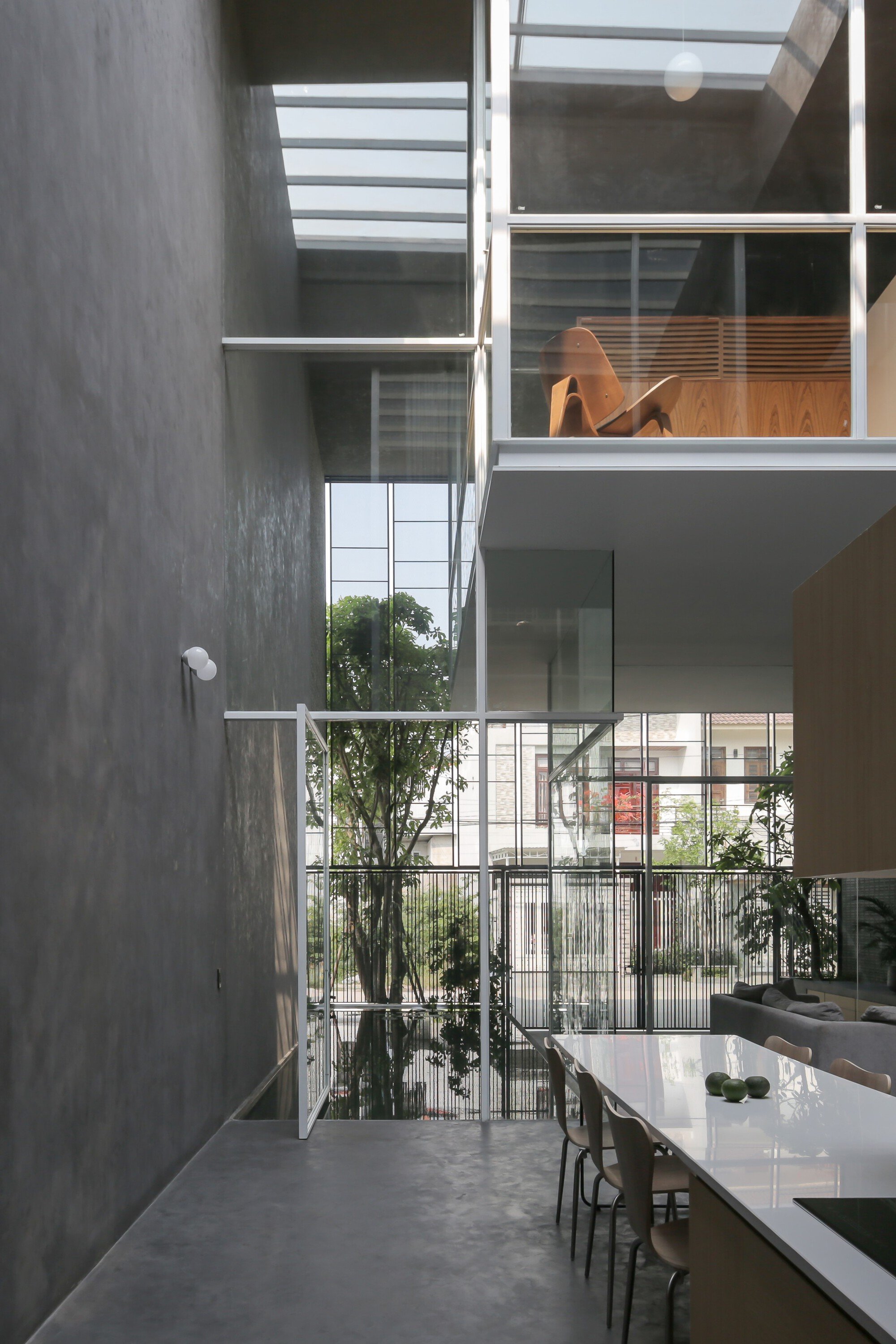 BHA Studio Suspends Glass Living Pods Inside a Nine-Meter Concrete Shell in Hue, Vietnam