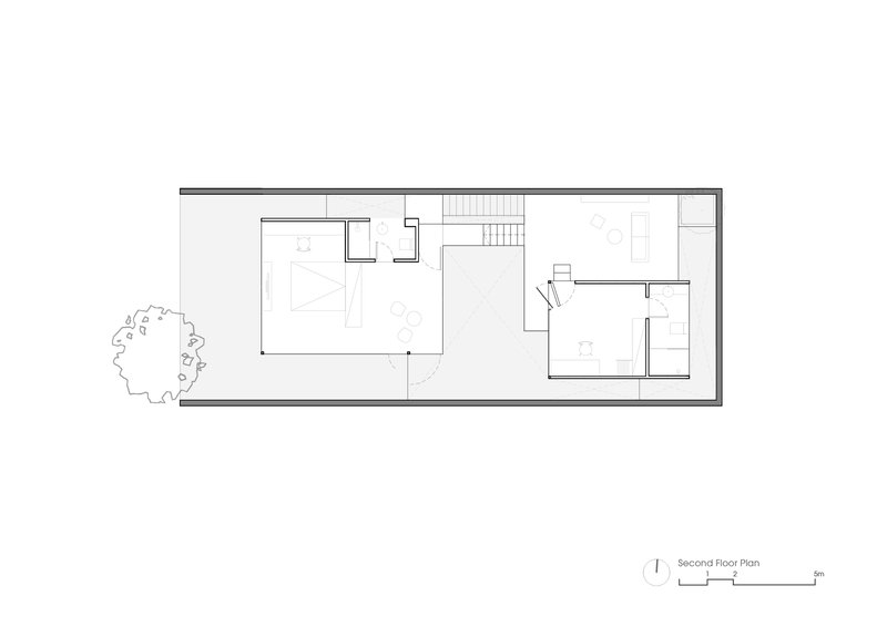 Second floor plan drawing showing open living areas, stair, and enclosed bedroom spaces