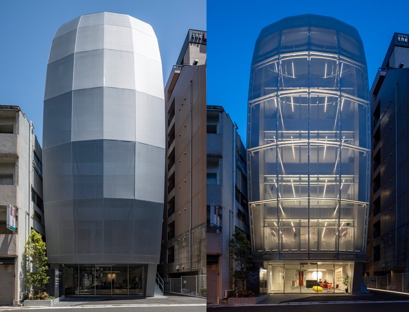 Street view comparing two cylindrical facades, one with frosted paneling and one with transparent glass