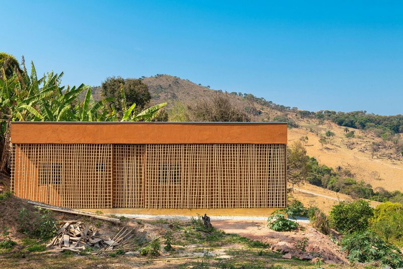 Long view of the slatted timber screen facade spanning the full length of the volume