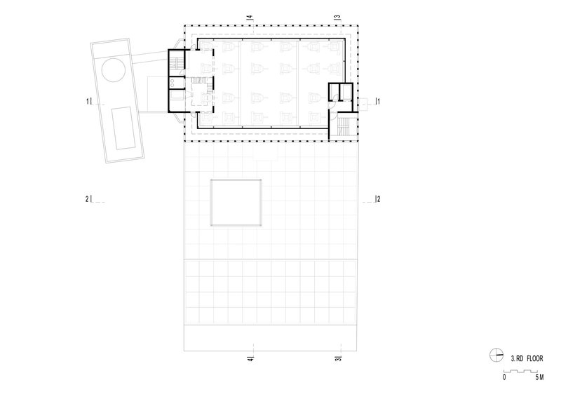 Third floor plan drawing displaying gridded exterior surfaces and enclosed interior zones with furnishings