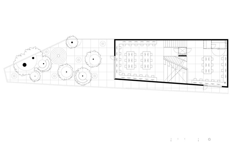 Ground floor plan showing workspaces flanking a central staircase with tree-lined courtyard to the left