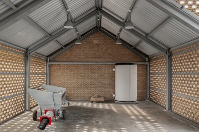 This architectural image showcases an industrial interior with a focus on brick and steel constructi
