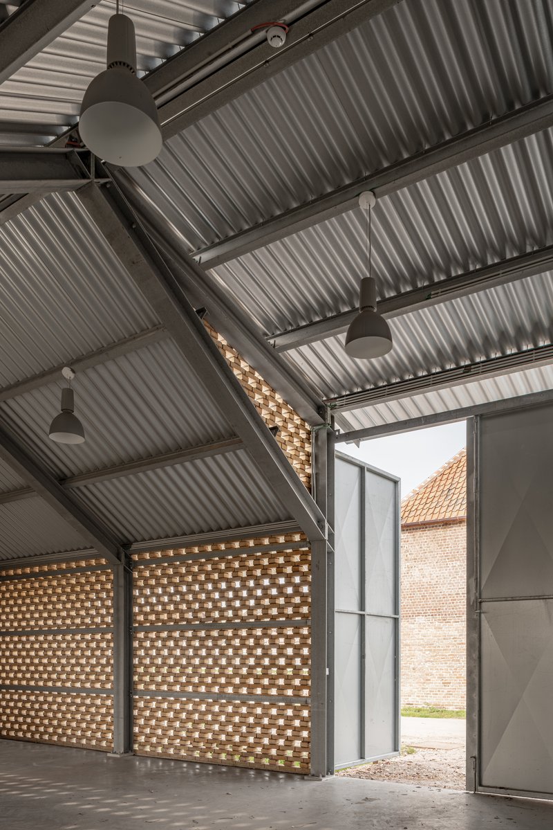 Large doors opening from interior space to courtyard framed by perforated brick screens