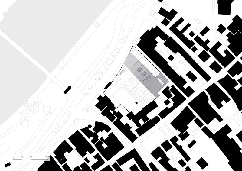 Site plan drawing showing the building footprint among surrounding urban blocks and streets