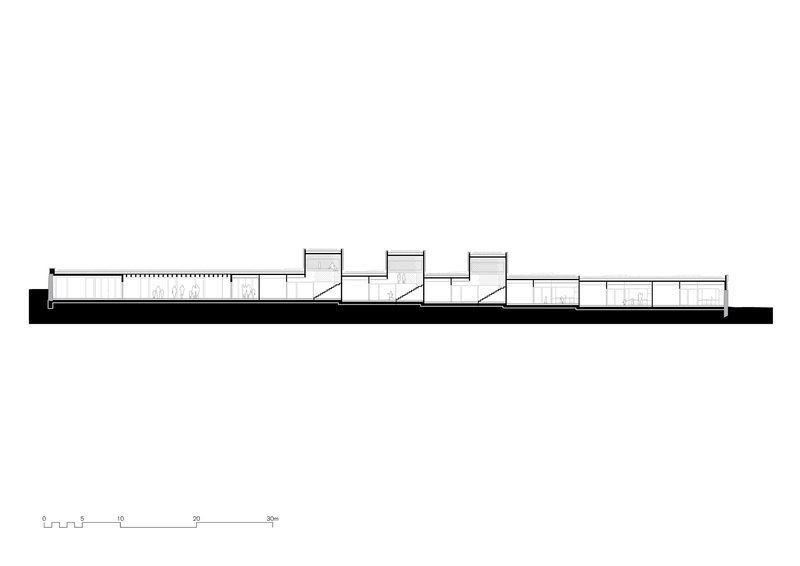 Longitudinal section drawing showing three sawtooth roof volumes stepping down a horizontal bar of rooms