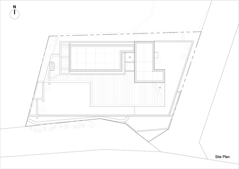 Site plan drawing showing a rectangular building with pool and deck on an angled trapezoidal lot
