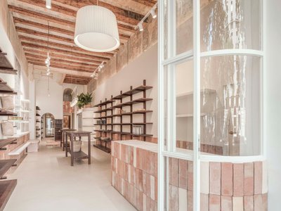 Berd Studio Lines a Barcelona Storefront with Mud Brick and Oak to Build a Social Market