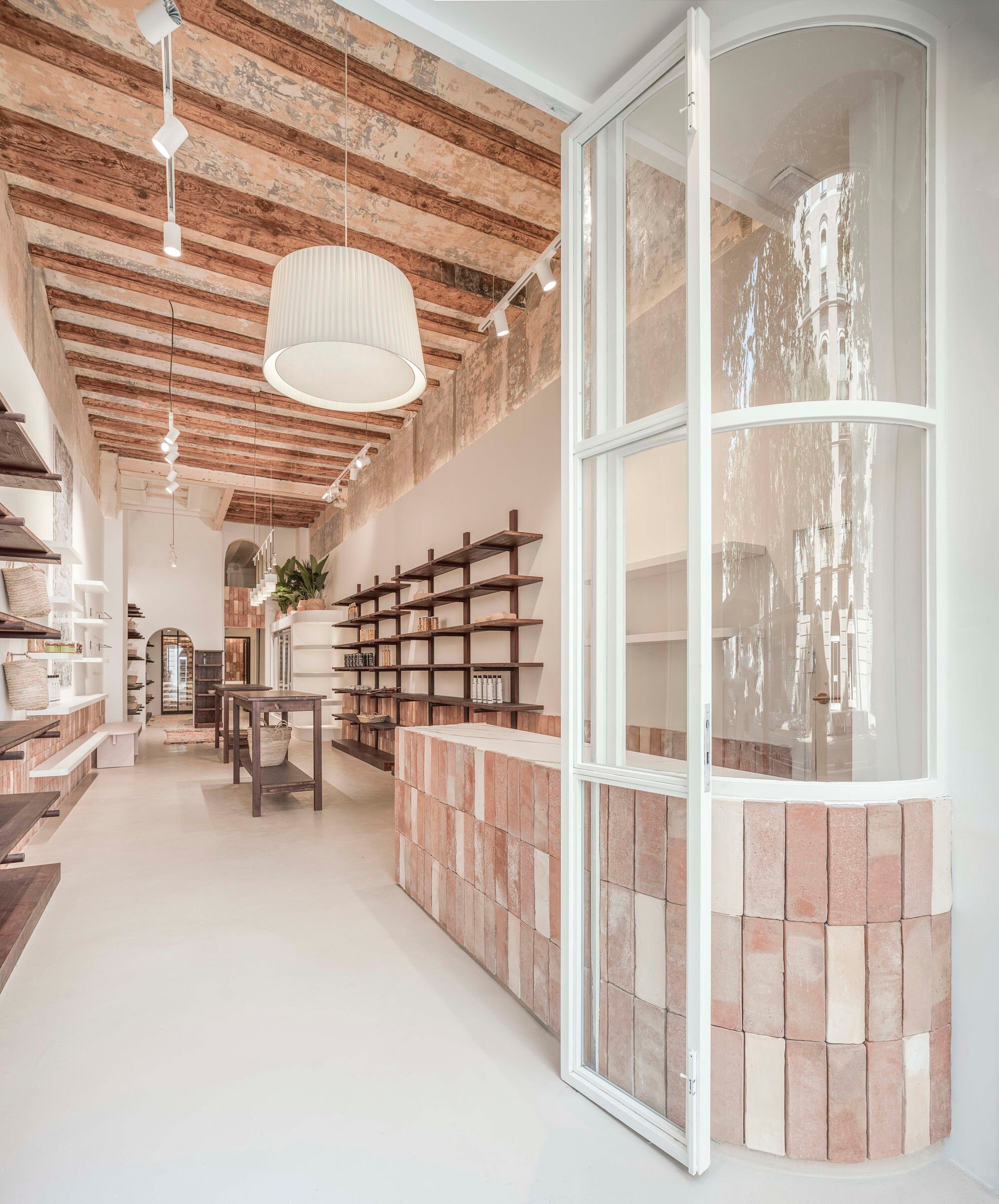 Berd Studio Lines a Barcelona Storefront with Mud Brick and Oak to Build a Social Market