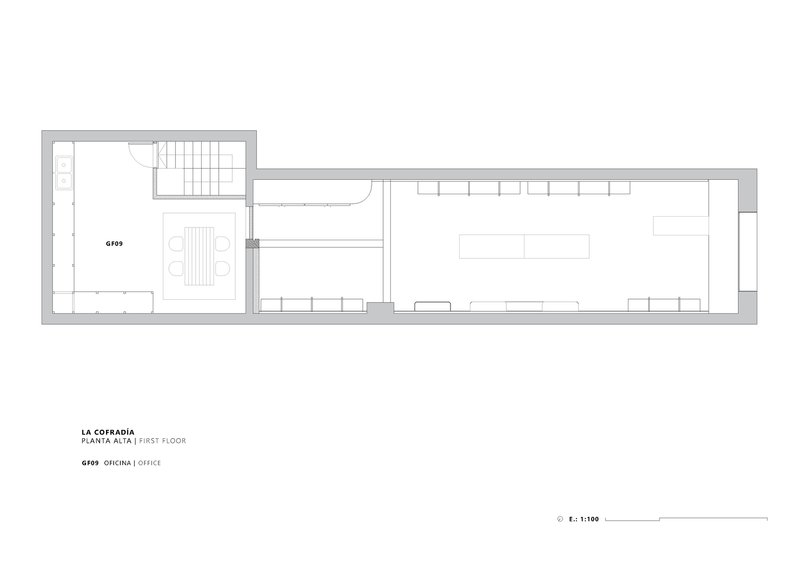 First floor plan drawing showing office space with conference table in front portion of building