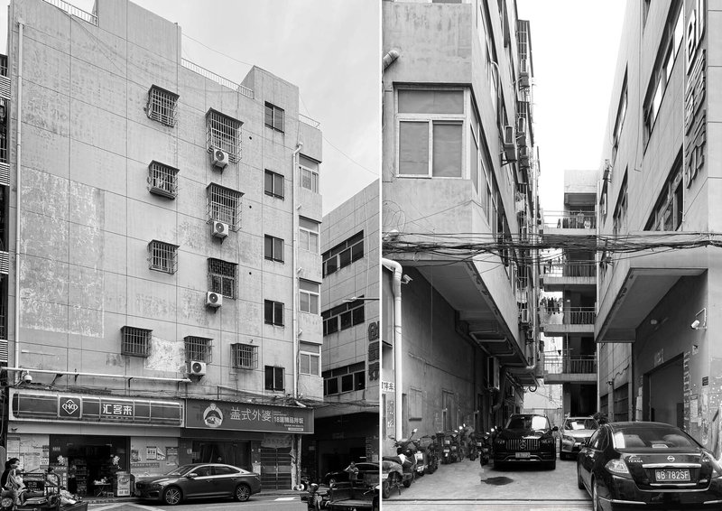 Black and white view of dense urban lane flanked by concrete buildings with air conditioning units