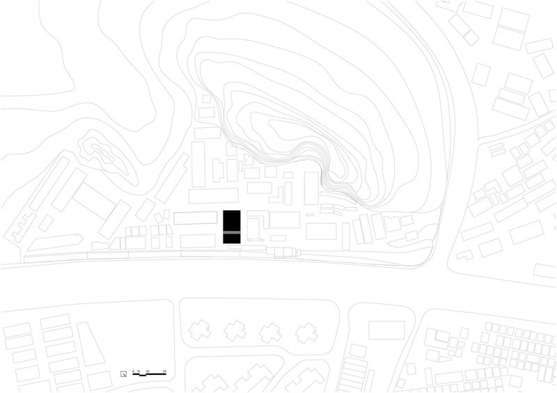 Site plan drawing showing two rectangular volumes within contoured topography and surrounding urban fabric
