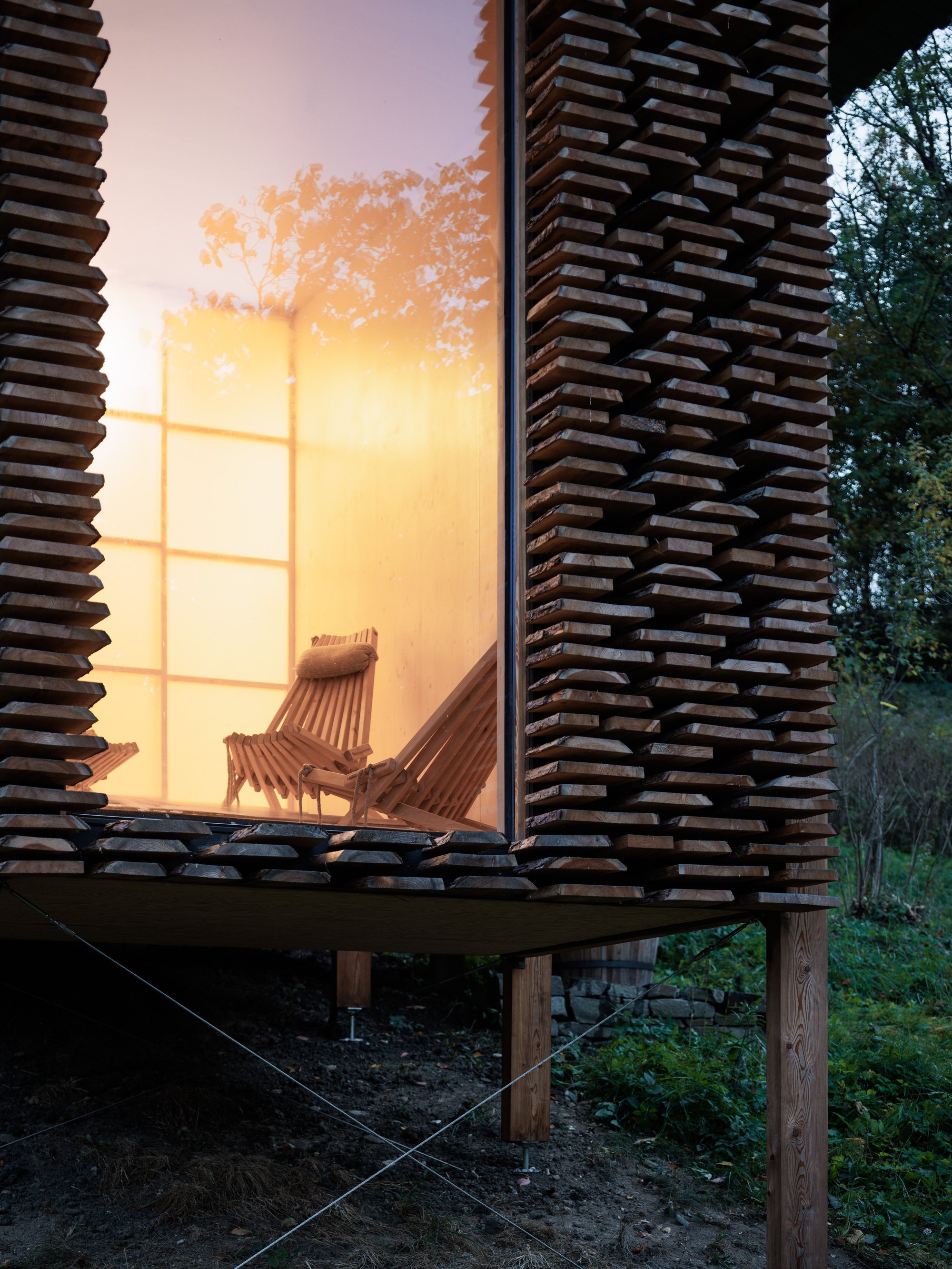 Guča arch Stacks Timber Like Firewood to Build a Forest Sauna in Rural Slovakia