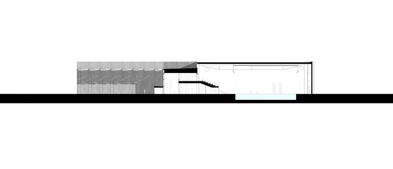 Section drawing showing a recessed volume with diamond-patterned wall and an interior staircase